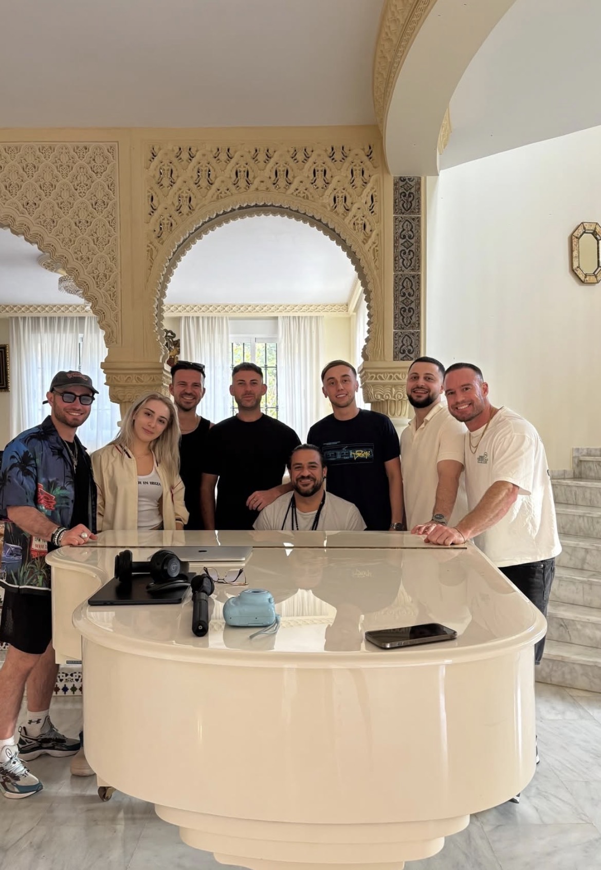 The crew together inside the villa