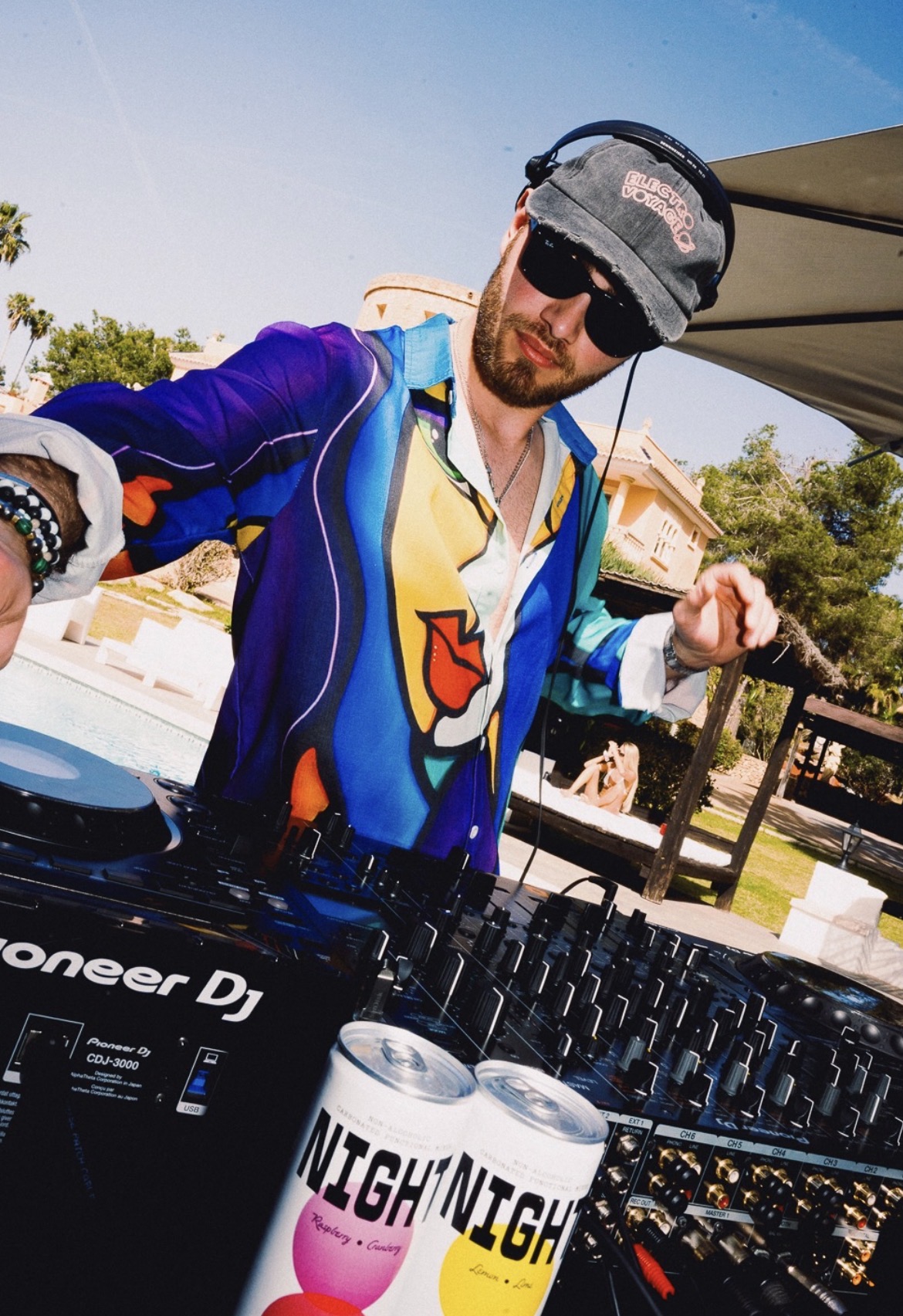 Resident playing the villa booth by the pool