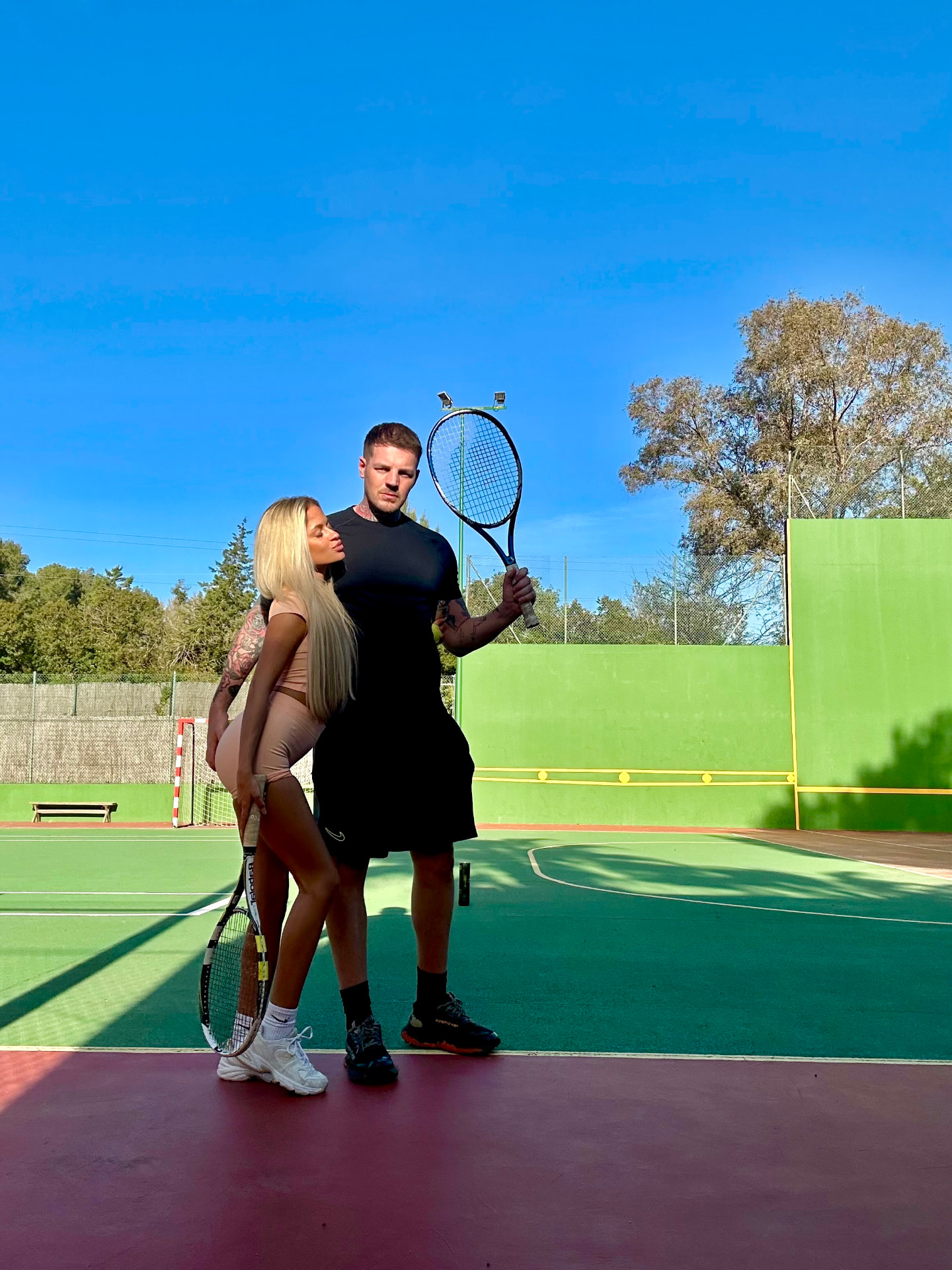 Guests on the villa tennis court